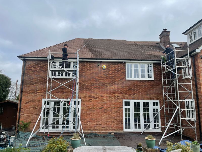 Roof cleaning carried out safely from scaffold towers by The Roof Moss Cleaners in Storrington